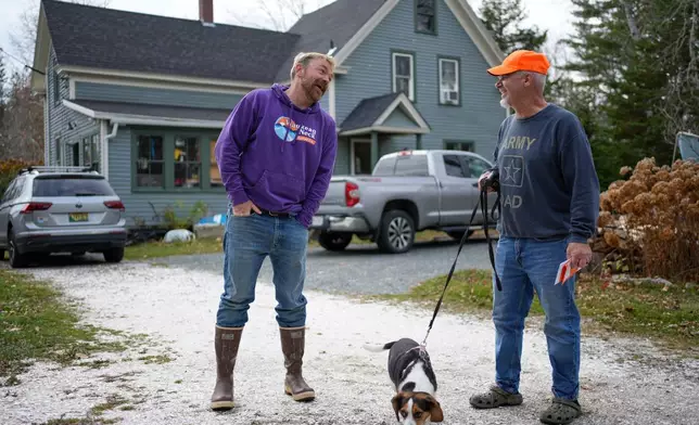 Graham Platner, Democratic candidate for U.S. Senate, chats with his neighbor, Denis Nault, Monday, Nov. 3, 2025, in Sullivan, Maine. (AP Photo/Robert F. Bukaty)