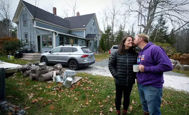 Graham Platner, Democratic candidate for U.S. Senate, kisses his wife, Amy Gertner, before she heads out, Monday, Nov. 3, 2025, in Sullivan, Maine. (AP Photo/Robert F. Bukaty)