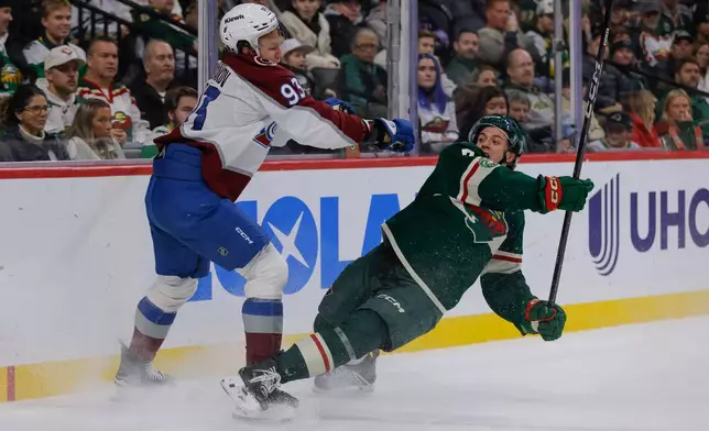 Colorado Avalanche center Zakhar Bardakov checks Minnesota Wild defenseman Brock Faber during the second period of an NHL hockey game, Friday, Nov. 28, 2025, in St. Paul, Minn. (AP Photo/Bailey Hillesheim)