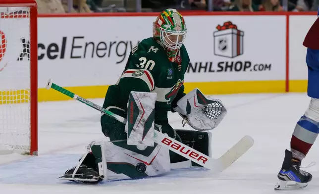 Minnesota Wild goaltender Jesper Wallstedt (30) makes a save during the second period of an NHL hockey game against the Colorado Avalanche, Friday, Nov. 28, 2025, in St. Paul, Minn. (AP Photo/Bailey Hillesheim)