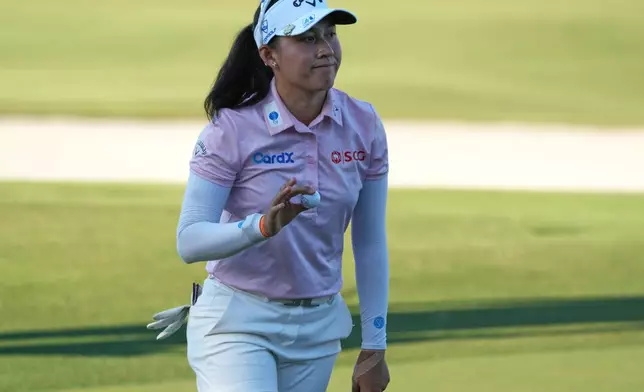 Jeeno Thitikul of Thailand shows her ball after making a birdie putt on the 17th hole during the second round of the LPGA Tour Championship golf tournament, Friday, Nov. 21, 2025, in Naples, Fla. (AP Photo/Marta Lavandier)