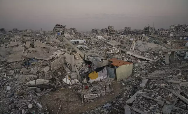A makeshift tent stands amid widespread devastation in Gaza City Thursday, Nov. 27, 2025. (AP Photo/Jehad Alshrafi)