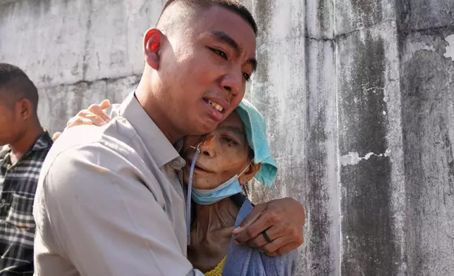 A boy, released from Insein prison, is welcomed by a family member in Yangon, Myanmar, Thursday, Nov. 27, 2025, after Myanmar's military rulers granted a mass amnesty ahead of elections. (AP Photo/Thein Zaw)