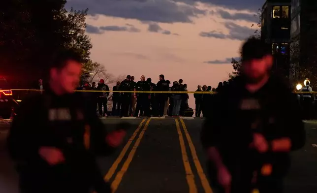Emergency personnel keep a presence following the shooting of two National Guard soldiers near the White House, Wednesday, Nov. 26, 2025, in Washington. (AP Photo/Mark Schiefelbein)