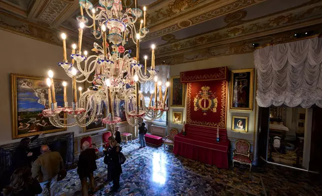 Journalists visit the Chapel Hall, featuring a baldachin bearing the Colonna family's coat of arms, inside Palazzo Colonna, or the Colonna Palace, in Rome during a media tour, Friday, Nov. 7, 2025. (AP Photo/Domenico Stinellis)