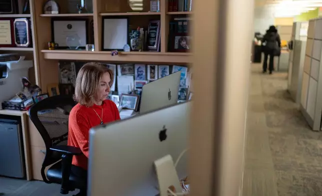 Dr. Mariana Kaplan, chief of the National Institute of Arthritis and Musculoskeletal and Skin Diseases at the National Institutes of Health, works in her office, Tuesday, Jan. 21, 2025, in Washington. (AP Photo/David Goldman)