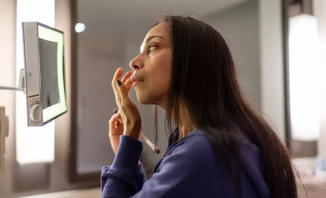 Ruth Wilson, who balances her lupus illness with volunteering to help other patients, puts on makeup as she gets ready for the Walk with Us to Cure Lupus fundraising event, Saturday, Oct. 18, 2025, in New York. (AP Photo/David Goldman)