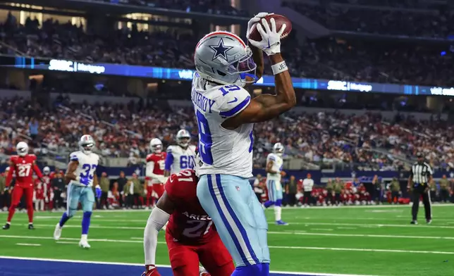 Dallas Cowboys wide receiver Ryan Flournoy (19) catches a touchdown pass as Arizona Cardinals cornerback Garrett Williams (21) defends in the second half of an NFL football game Monday, Nov. 3, 2025, in Arlington, Texas. (AP Photo/Richard Rodriguez)