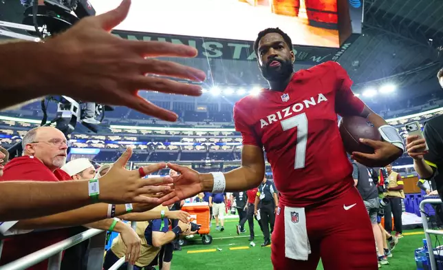 Arizona Cardinals' Jacoby Brissett (7) greets fans as he walks off the field following an NFL football game against the Dallas Cowboys Monday, Nov. 3, 2025, in Arlington, Texas. (AP Photo/Richard Rodriguez)