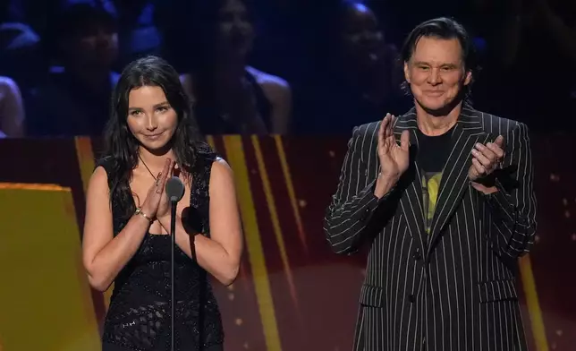 Lillian Cornell and Jim Carrey speak during the 2025 Rock and Roll Hall of Fame Induction Ceremony on Saturday, Nov. 8, 2025, at L.A. Live in Los Angeles. (AP Photo/Chris Pizzello)