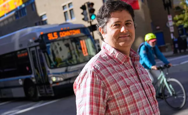 Bernie Hernandez, who lives at the Pok Oi Residences, poses in his Chinatown neighborhood, Oct. 17, 2025, in Boston. (AP Photo/Charles Krupa)