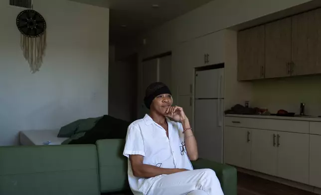 Quantavia Smith sits for a photo in her studio apartment at the Santa Monica and Vermont Apartments in Los Angeles, Monday, Nov. 10, 2025. (AP Photo/Jae C. Hong)