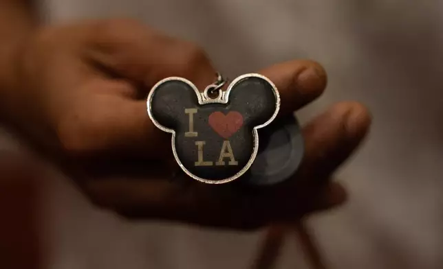 Quantavia Smith shows a keychain outside her studio apartment in the Santa Monica and Vermont Apartments complex in Los Angeles, Monday, Nov. 10, 2025. (AP Photo/Jae C. Hong)