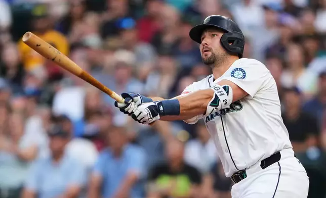 FILE - Seattle Mariners designated hitter Cal Raleigh hits a solo home run against the San Diego Padres during the first inning of a baseball game Monday, Aug. 25, 2025, in Seattle. (AP Photo/Lindsey Wasson, File)