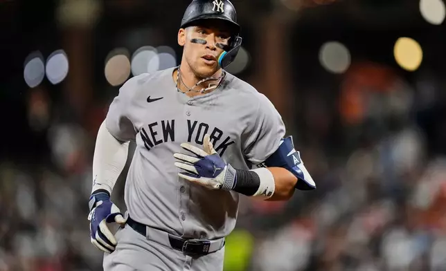 FILE - New York Yankees' Aaron Judge rounds the bases after hitting a home run during the third inning of a baseball game against the Baltimore Orioles, Sept. 20, 2025, in Baltimore. (AP Photo/Stephanie Scarbrough, File)