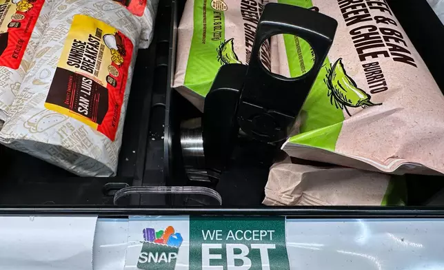 A SNAP EBT sign is displayed on a shelf at a gas station in Riverwoods, Ill., Saturday, Nov. 1, 2025. (AP Photo/Nam Y. Huh)
