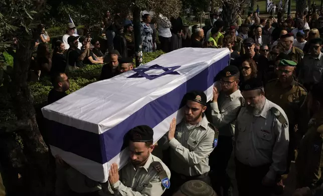 Members of Israel forces carry the coffin of slain hostage Israeli-American Capt. Omer Neutra, after his body was returned from Gaza as part of a ceasefire agreement between Israel and Hamas, at Kiryat Shaul cemetery, in Tel Aviv, Friday, Nov. 7, 2025. (AP Photo/Leo Correa)