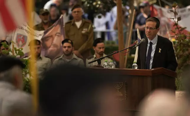 Israeli President Isaac Herzog speaks during the funeral of slain hostage Israeli-American Capt. Omer Neutra, after his body was returned from Gaza as part of a ceasefire agreement between Israel and Hamas, at Kiryat Shaul cemetery, in Tel Aviv, Friday, Nov. 7, 2025. (AP Photo/Leo Correa)