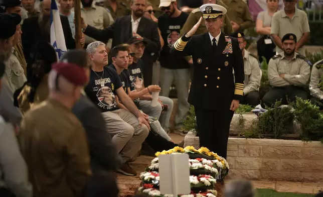 U.S. Central Command (CENTCOM) Commander Admiral Brad Cooper salutes during the funeral of slain hostage Israeli-American Capt. Omer Neutra, after his body was returned from Gaza as part of a ceasefire agreement between Israel and Hamas, at Kiryat Shaul cemetery, in Tel Aviv, Friday, Nov. 7, 2025. (AP Photo/Leo Correa)