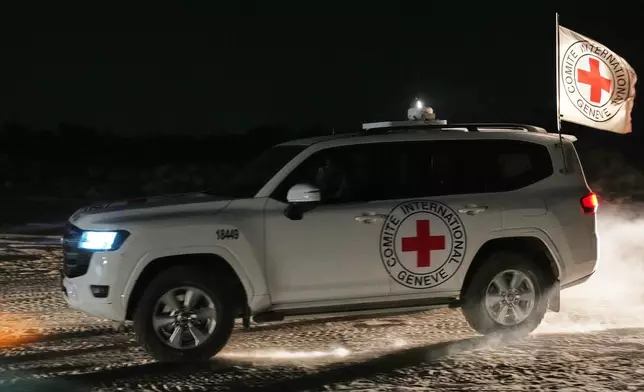 Red Cross convoy carrying the body of a person believed to be a deceased hostage handed over by Palestinians militants makes its way toward the border crossing with Israel, to be transferred to Israeli authorities, in Deir al-Balah, central Gaza Strip, Friday, Nov. 7, 2025. (AP Photo/Abdel Kareem Hana)