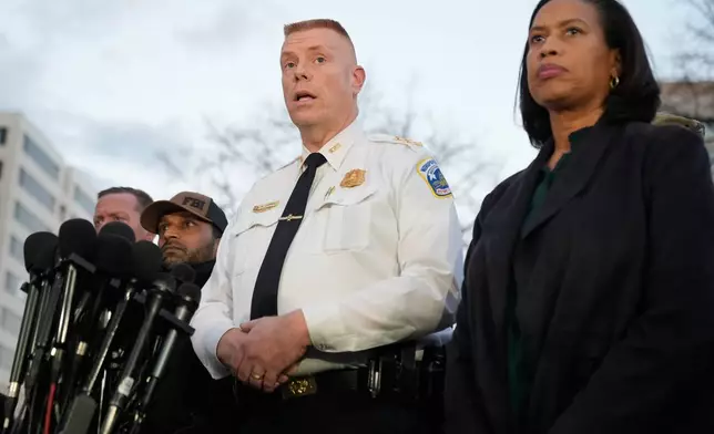 Flanked by District of Columbia Mayor Muriel Bowser, right, Executive Assistant Chief, Metropolitan Police Department Jeffery Carroll speaks during a press conference following the shooting of two National Guard soldiers near the White House Wednesday, Nov. 26, 2025, in Washington. (AP Photo/Mark Schiefelbein)