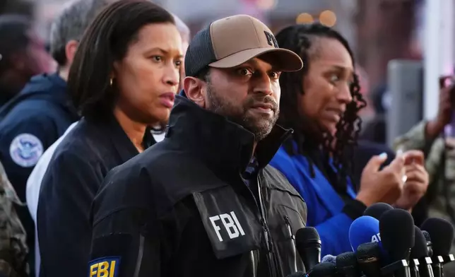 FBI Director Kash Patel, center, and District of Columbia Mayor Muriel Bowser, left, arrive to speak to a news conference near the scene where two National Guard soldiers were shot near the White House in Washington, Wednesday, Nov. 26, 2025. (AP Photo/Anthony Peltier)