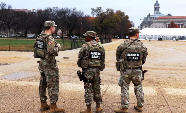 National Guard patrol on the National Mall near the U.S. Capitol, Wednesday, Nov. 26, 2025, in Washington. (AP Photo/Rahmat Gul)