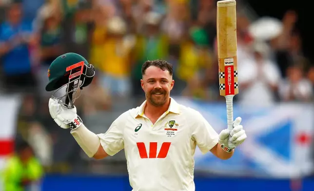 Australia's Travis Head celebrates his century on day two of the first Ashes cricket test match between Australia and England in Perth, Saturday, Nov. 22, 2025.(AP Photo/Gary Day)