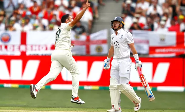 Australia's Scott Boland, left, celebrates the wicket of England's Ollie Pope on day two of the first Ashes cricket test match between Australia and England in Perth, Saturday, Nov. 22, 2025.(AP Photo/Gary Day)