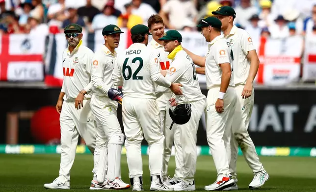 Australia's players celebrate the wicket of England's Jofra Archer on day two of the first Ashes cricket test match between Australia and England in Perth, Saturday, Nov. 22, 2025.(AP Photo/Gary Day)