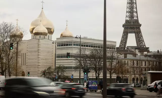 The Holy-Trinity Russian orthodox Cathedral and the adjoining culture center, right, are seen next to the Eiffel Tower in Paris, Wednesday, Nov. 26, 2025. (AP Photo/Thomas Padilla)