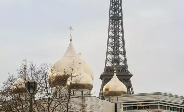 The Holy-Trinity Russian orthodox Cathedral and the adjoining culture center, right, are seen next to the Eiffel Tower in Paris, Wednesday, Nov. 26, 2025. (AP Photo/Thomas Padilla)