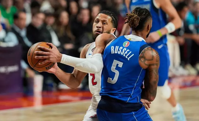Dallas Mavericks guard D'Angelo Russell challenges Detroit Pistons guard Cade Cunningham during the first half of an NBA basketball game in Mexico City, Saturday, Nov. 1, 2025. (AP Photo/Fernando Llano)