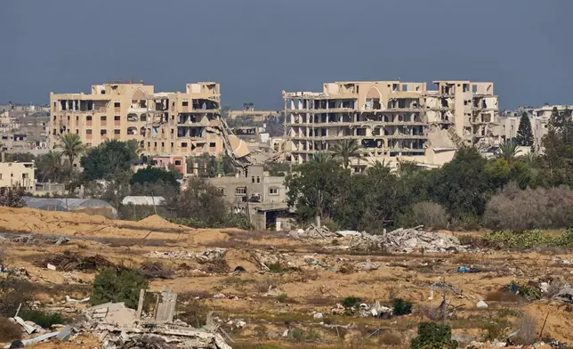 Destroyed buildings in the Gaza Strip are seen from southern Israel, Tuesday, Nov. 18, 2025. (AP Photo/Ohad Zwigenberg)