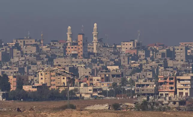 Destroyed buildings in the Gaza Strip are seen from southern Israel, Tuesday, Nov. 18, 2025. (AP Photo/Ohad Zwigenberg)