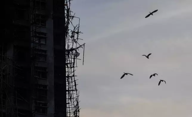 A burned building is seen at the scene of the fire that started Wednesday at Wang Fuk Court, a residential estate in the Tai Po district of Hong Kong's New Territories, Friday, Nov. 28, 2025. (AP Photo/Chan Long Hei)