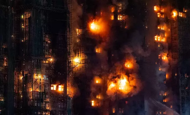 Firefighters work to extinguish a fire which broke out at Wang Fuk Court, a residential estate in the Tai Po district of Hong Kong's New Territories, Wednesday, Nov. 26, 2025. (AP Photo/Chan Long Hei)