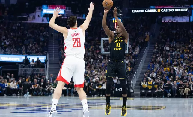 Golden State Warriors forward Jimmy Butler III shoots past Houston Rockets center Alperen Şengün during the first half of an Emirates NBA Cup basketball game, Wednesday, Nov. 26, 2025, in San Francisco. (AP Photo/Benjamin Fanjoy)