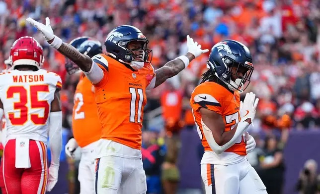 Denver Broncos running back Jaleel McLaughlin celebrates alongside teammate Troy Franklin, left, after scoring during the second half an NFL football game against the Kansas City Chiefs Sunday, Nov. 16, 2025, in Denver. (AP Photo/Jack Dempsey)