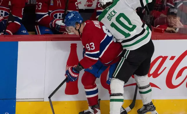 Montreal Canadiens' Ivan Demidov (93) breaks his stick as he is checked by Dallas Stars' Oskar Back (10) during first-period NHL hockey game action in Montreal, Thursday, Nov. 13, 2025. (Christinne Muschi/The Canadian Press via AP)