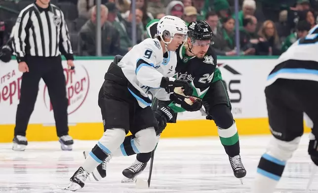 Utah Mammoth right wing Clayton Keller (9) and Dallas Stars center Roope Hintz (24) position for a puck drop during the first period of an NHL hockey game Friday, Nov. 28, 2025, in Dallas. (AP Photo/LM Otero)