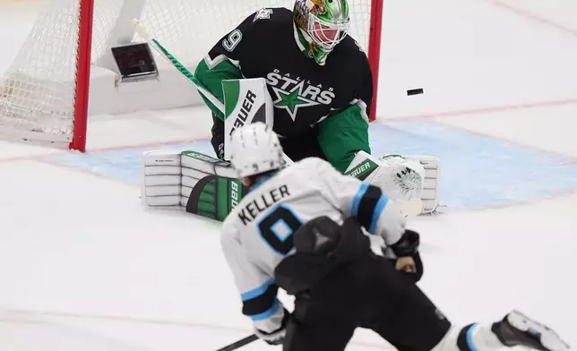 Dallas Stars goaltender Jake Oettinger (29) defends the goal against Utah Mammoth right wing Clayton Keller (9) during the second period of an NHL hockey game Friday, Nov. 28, 2025, in Dallas. (AP Photo/LM Otero)