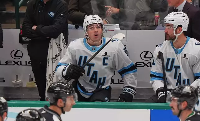 Utah Mammoth right wing Clayton Keller looks up from the bench during the second period of an NHL hockey game against the Dallas Stars Friday, Nov. 28, 2025, in Dallas. (AP Photo/LM Otero)