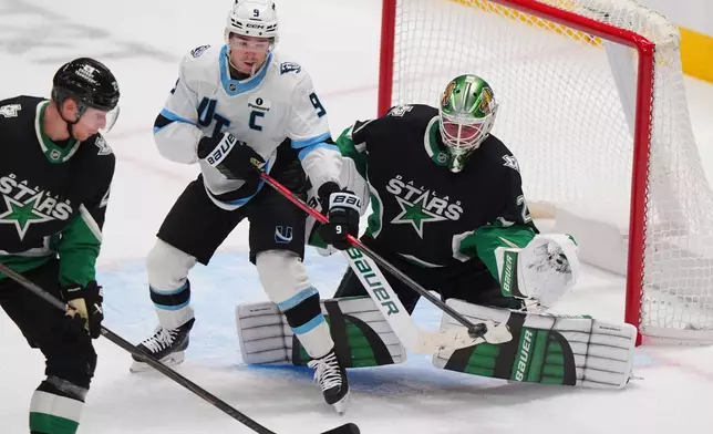 Dallas Stars goaltender Jake Oettinger (29) and defenseman Esa Lindell (23) defend the goal against Utah Mammoth right wing Clayton Keller (9) during the third period of an NHL hockey game Friday, Nov. 28, 2025, in Dallas. (AP Photo/LM Otero)