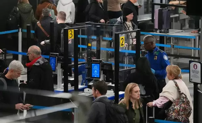 Travelers line up at a TSA checkpoint at O'Hare International Airport in Chicago, Wednesday, Nov. 12, 2025. (AP Photo/Nam Y. Huh)