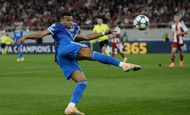 Real Madrid's Kylian Mbappe attempts a shot on goal during the Champions League opening phase soccer match between Olympiacos and Real Madrid in Piraeus port, near Athens, Greece, Wednesday, Nov. 26, 2025. (AP Photo/Thanassis Stavrakis)
