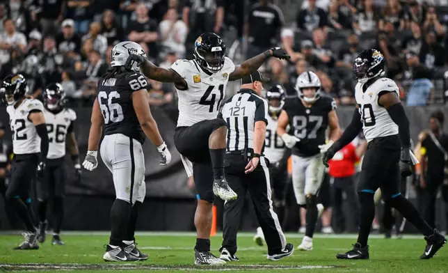 Jacksonville Jaguars defensive end Josh Hines-Allen (41) reacts after a sack during overtime of an NFL football game against the Las Vegas Raiders, Sunday, Nov. 2, 2025, in Las Vegas. (AP Photo/David Becker)