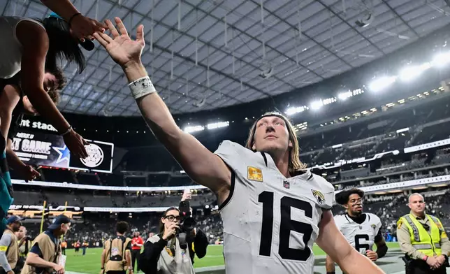 Jacksonville Jaguars quarterback Trevor Lawrence (16) exits the field after the team's victory over the Las Vegas Raiders in an NFL football game, Sunday, Nov. 2, 2025, in Las Vegas. (AP Photo/David Becker)