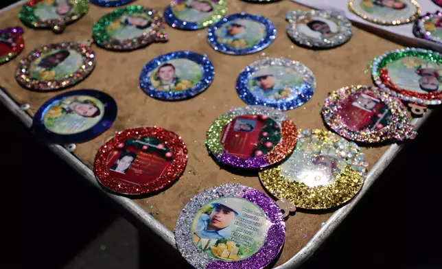 Christmas ornaments with photographs of the missing sit to dry before hanging on the Tree of Hope during an event organized by the diocese of Ecatepec at the Church of the Sacred Heart of San Cristobal in Ecatepec, State of Mexico, Monday, Nov. 17, 2025. (AP Photo/Ginnette Riquelme)