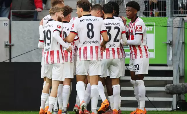 Freiburg's players celebrate the opening goal during the German Bundesliga soccer match between SC Freiburg and FC St. Pauli in Freiburg, Germany, Sunday, Nov. 9, 2025. (Philipp von Ditfurth/dpa via AP)
